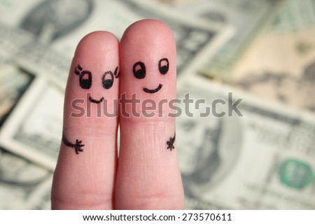 Finger art of a Happy couple. A man and a woman hug on the background of money.