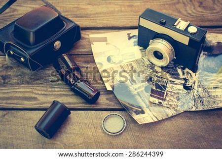 Retro camera and old black-white photographs. Toned image