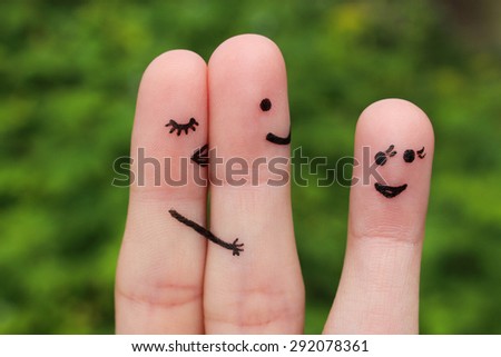 Finger art of a couple.  Woman hugs and kisses the man, and he\'s flirting with another woman. The concept is not shared love.