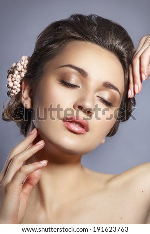 Beautiful Woman Touching her Face. Youth and Skin Care Concept. Spa woman.Beautiful woman with professional make up looking down.