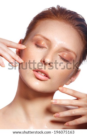 Beautiful Spa Woman Touching her chin. Youth and Skin Care Concept. Beautiful girl after a shower with wet hair and clean skin. Natural beauty. Sensual and Fresh