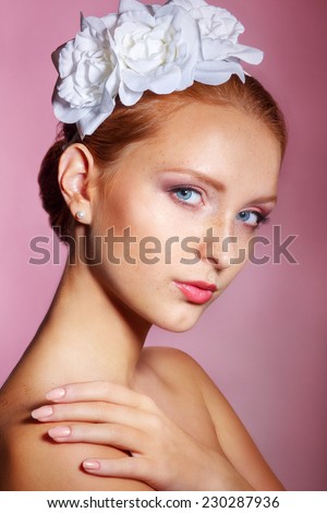 Bridal Beauty .Beautiful young woman with professional make up ..Bride\'s portrait on a pink background.Youth and Skin Care Concept.Girl with red hair