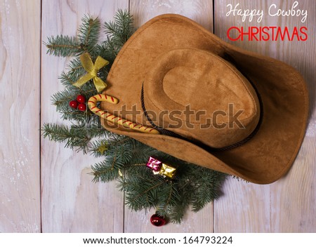 American western cowboy hat with Christmas decoration on wood background