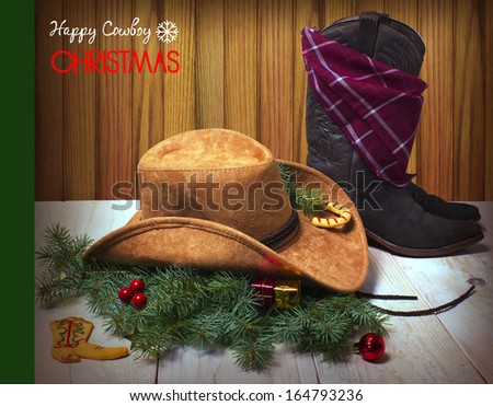 Christmas image with cowboy hat and boot on wood background