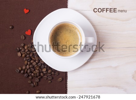 Black coffee in white cup with beans and hearts.Coffee menu background