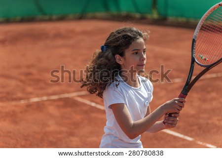 young tennis player playing tennis