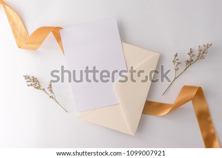 A wedding mock up concept. Wedding Invitation, envelopes, cards Papers on white background with ribbon and decoration. Top view, flat lay, copy space