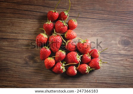 Strawberry on Wooden texture for background, Valentines Day Heart Made of Strawberry