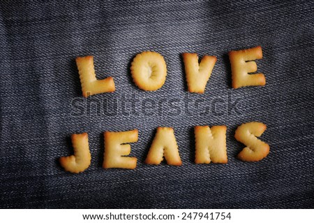 Cookies ABC in the form of word LOVE JEANS alphabet on old jean background, Valentines day