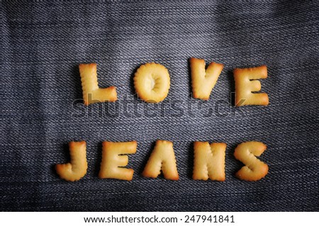 Cookies ABC in the form of word LOVE JEANS alphabet on old jean background, Valentines day