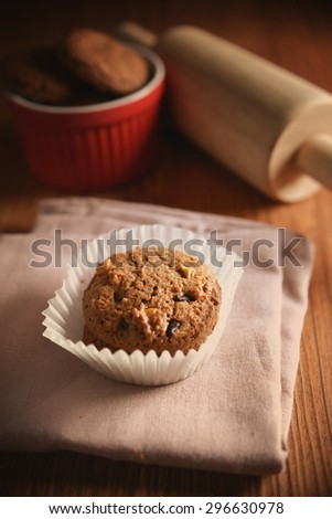 Chocolate cookies on pink napkin on wooden background. Chocolate chip cookies shot on colored cloth, closeup.