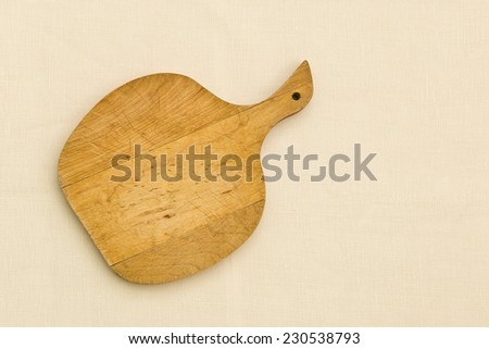 old apple shaped cutting board on fabric