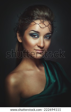 Girl in a dark colored dress, looking ahead, she bright makeup. Girl oriental appearance, asian,