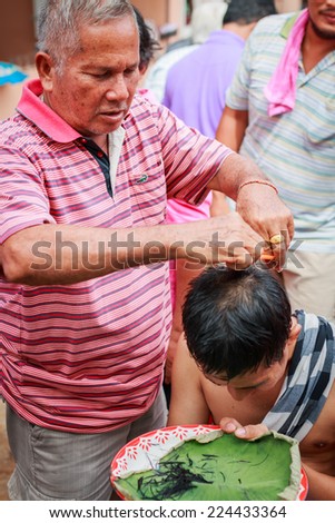 SONGKLA,THAILAND JULY 6 : Male who will be monk cut hair for be Ordained. Thailand on July 6, 2014