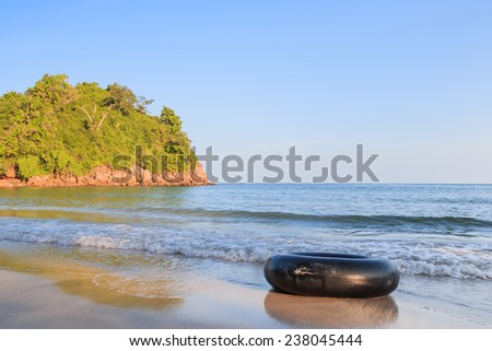 Background stone beach, with blue sky and sand