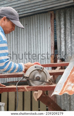 CHUMPON, THAILAND - SEPTEMBER 9, 2014 : The carpenter repairing the old roof in the morning on September 9, 2014 at Chumpon, Prachuap keereekhun, Thailand.