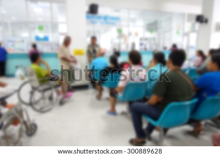 Blurred image of unidentified people and patient in hospital waiting medicine or doctor.