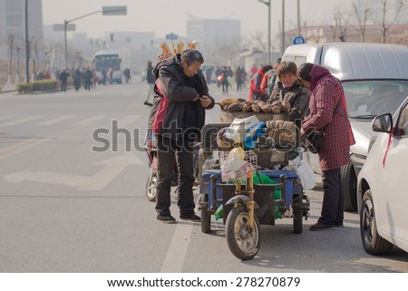 Dec 30, 2013, Shanghai - Street Vendor Selling Roasted Sweet Potato Late Afternoon