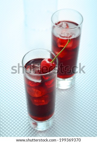 glass of cherry juice and cherry