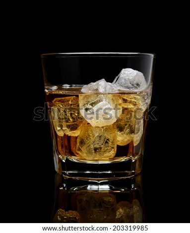 glass of whiskey with ice on a black background