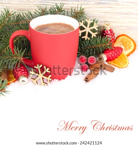 Red mug with hot chocolate and dried oranges on a white background.