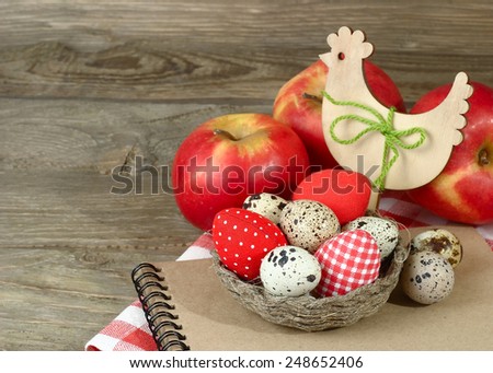 Easter background with eggs, apples and wooden chicken.