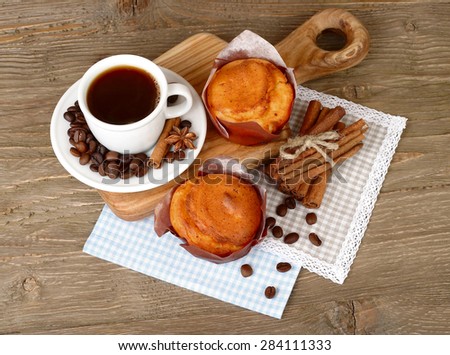 Cup of coffee with cakes and coffee grains on a wooden background. Top view.