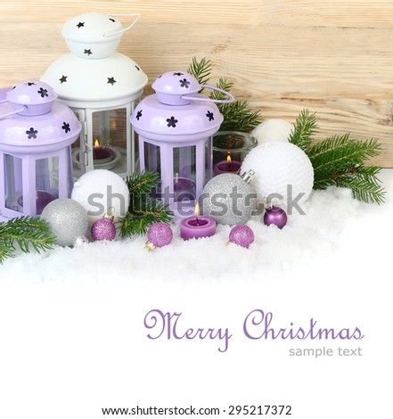 Violet and white lamps candlesticks and Christmas balls on snow on a white background. A Christmas background with a place for the text.