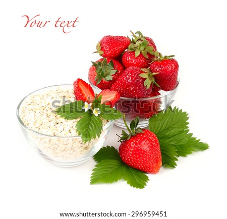 Ripe fragrant strawberry and oat flakes in transparent ware on a white background with a place for the text.