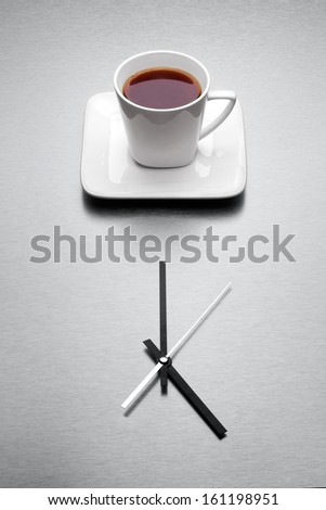 A White Mug Filled With Tea Over Minimalistic Clock.