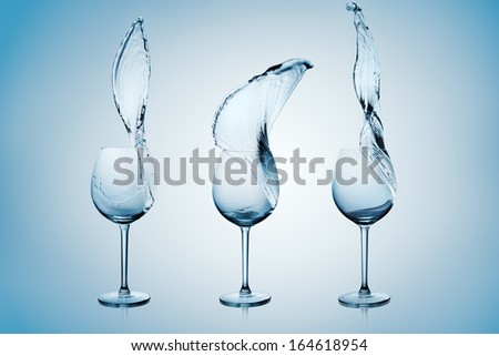 Water Splashing Out Of A Tall Wine Glass.