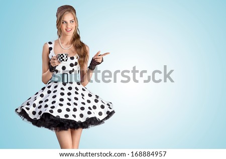 A Creative Vintage Photo Of A Beautiful Pin-Up Girl In A Polka-Dot Dress Holding A Cup Of Tea.