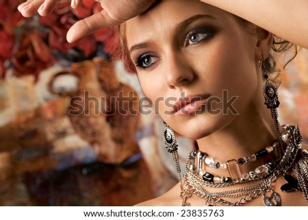  A Young Glamorous Woman Wearing Stylish Necklace And Pierced Earrings.