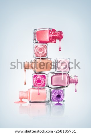 Nail polish dripping from stacked bottles.