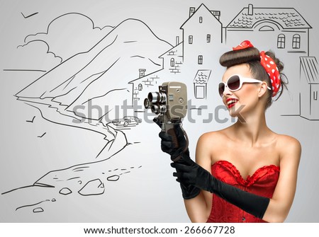 Glamorous pin-up tourist girl filming landscape with an old retro cinema 8 mm camera, standing on sketchy background.