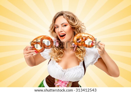 Young Oktoberfest woman wearing a traditional Bavarian dress dirndl laughing happily and holding two pretzels in hands on colorful abstract looney tunes logo style background.