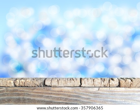 Old  wood table top on blue blurred light abstract background . use  for display or montage your products