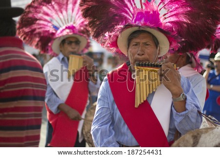 IQUIQUE, CHILE - JANUARY 27, 2012: Indigenous men play the flute during a street performance celebrating their traditions. January 27, 2012 in Iquique, Chile.