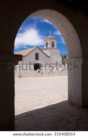 The church of San Pedro de Atacama, Chile as seen from an arch from across the street
