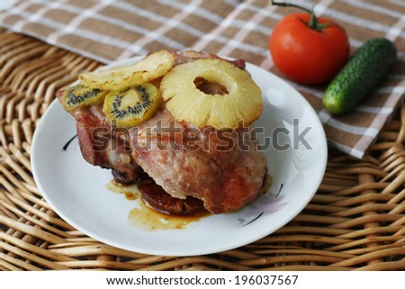 roasted turkey meat with pineapple and kiwi on a plate
