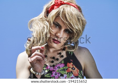 Beautiful drag queen wearing a blonde wig and looking