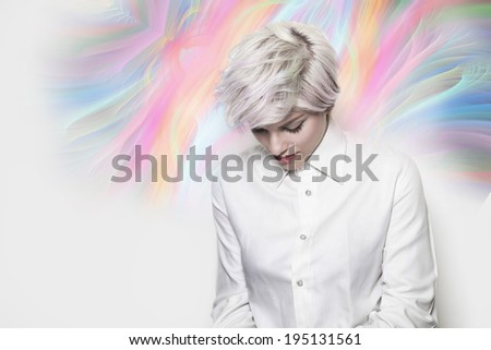 Beautiful thoughtful girl with dyed hair wearing a white shirt