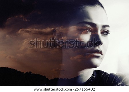 Double exposure of beautiful girl and red cloudscape