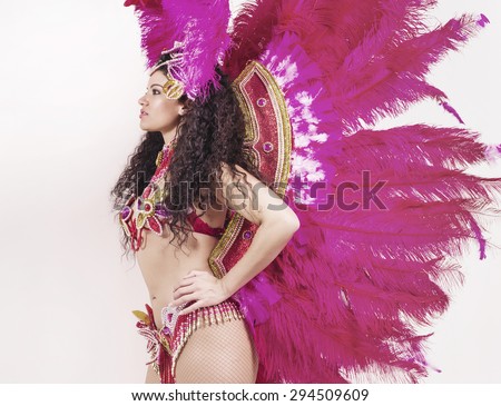 Brazilian samba dancer wearing traditional pink costume profile