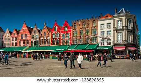 BRUGES - MAY 9: Medieval style shops and restaurants around the market place (Grote Markt) on May 9, 2013 in Bruges, Belgium. The market place is free from traffic since October 1996.