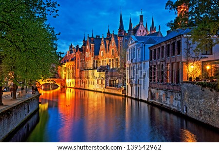 Night shot of historic medieval buildings along a canal in Bruges, Belgium
