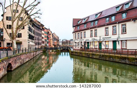 STRASBOURG, FRANCE - MARCH 19: People are sitting at cafes in Petite-France on March 19, 2013 in Strasbourg. Petite-France is an historic area in the center of Strasbourg.