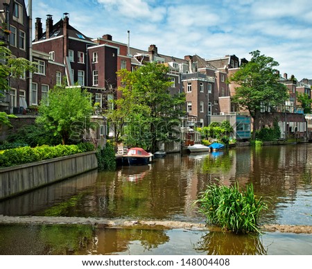 AMSTERDAM, THE NETHERLANDS - 29 JUNE : Canals of Amsterdam on 29 June 2013. Amsterdam is the capital and most populous city of the Netherlands.