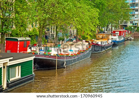 AMSTERDAM, THE NETHERLANDS - 29 JUNE : Canals of Amsterdam on 29 June 2013. Amsterdam is the capital and most populous city of the Netherlands.