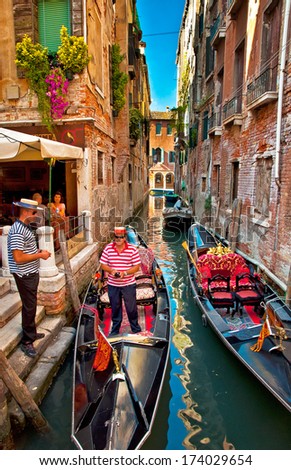 VENICE, ITALY - 14 SEPTEMBER, 2013: Narrow canal with boat in Venice, Italy. The city in its entirety is listed as a World Heritage Site, along with its lagoon.